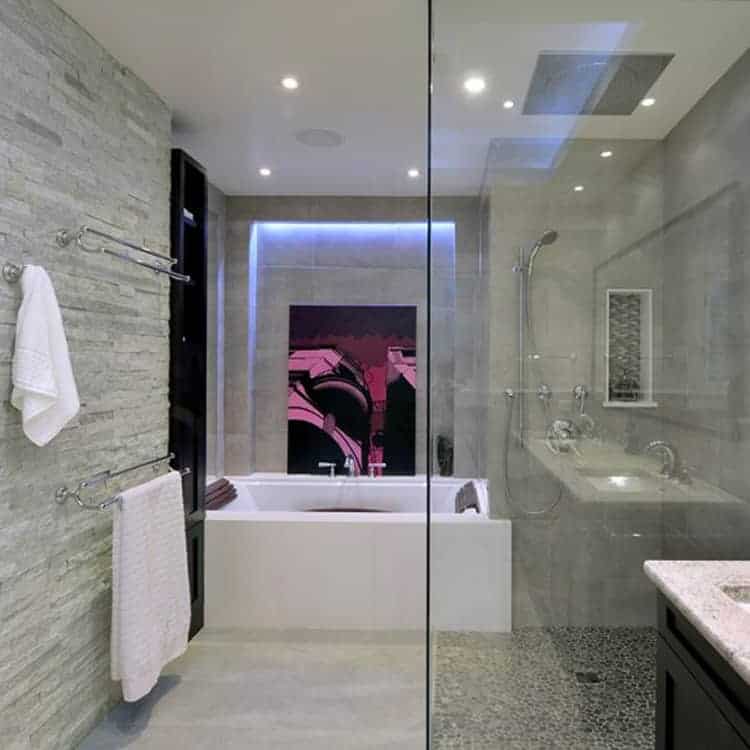 A modern bathroom with a blue cabinet, tile and stone back splash, and  marble tiling the floor / shower. Stock Photo