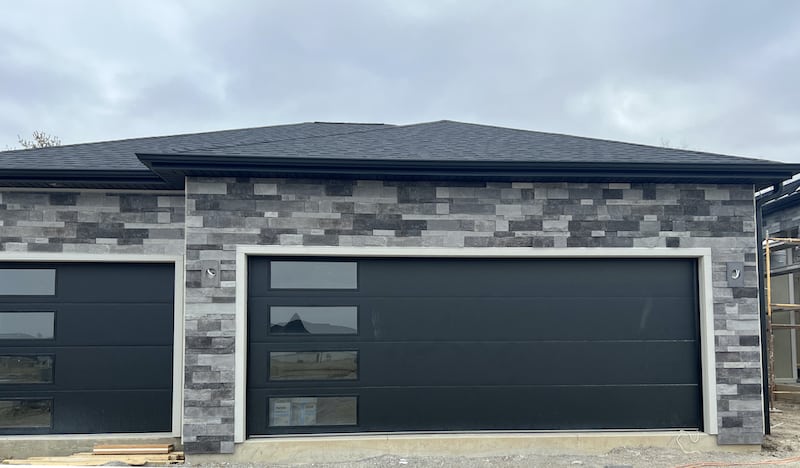 grey faux stone for home exterior and modern garage doors