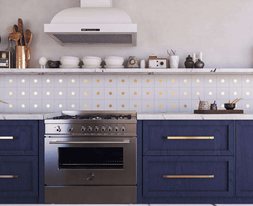 cement tile with brass inlay in a star pattern on a kitchen backsplash