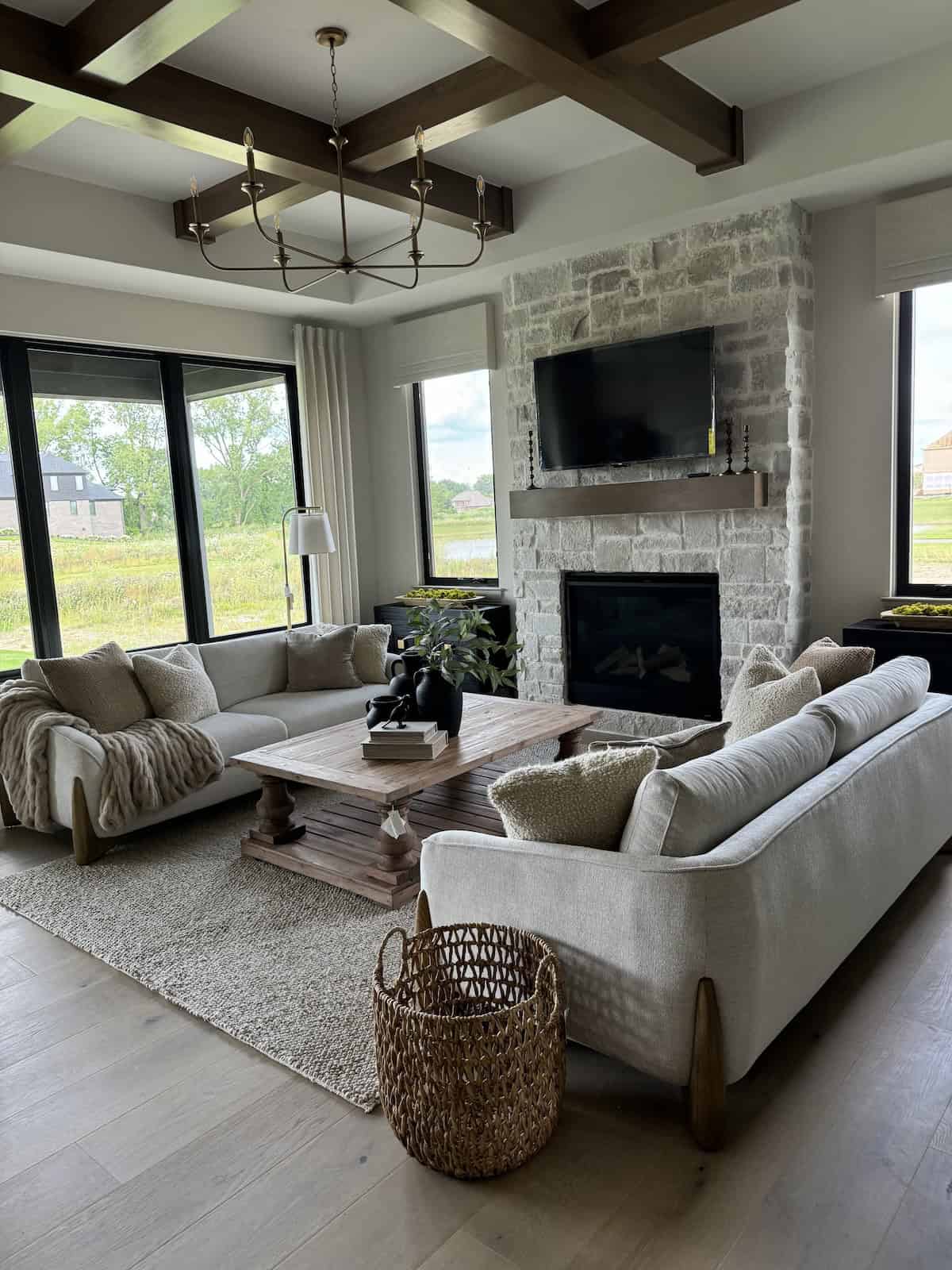 large format light colored rustic stone on a fireplace in a brightly lit living room with rustic decor