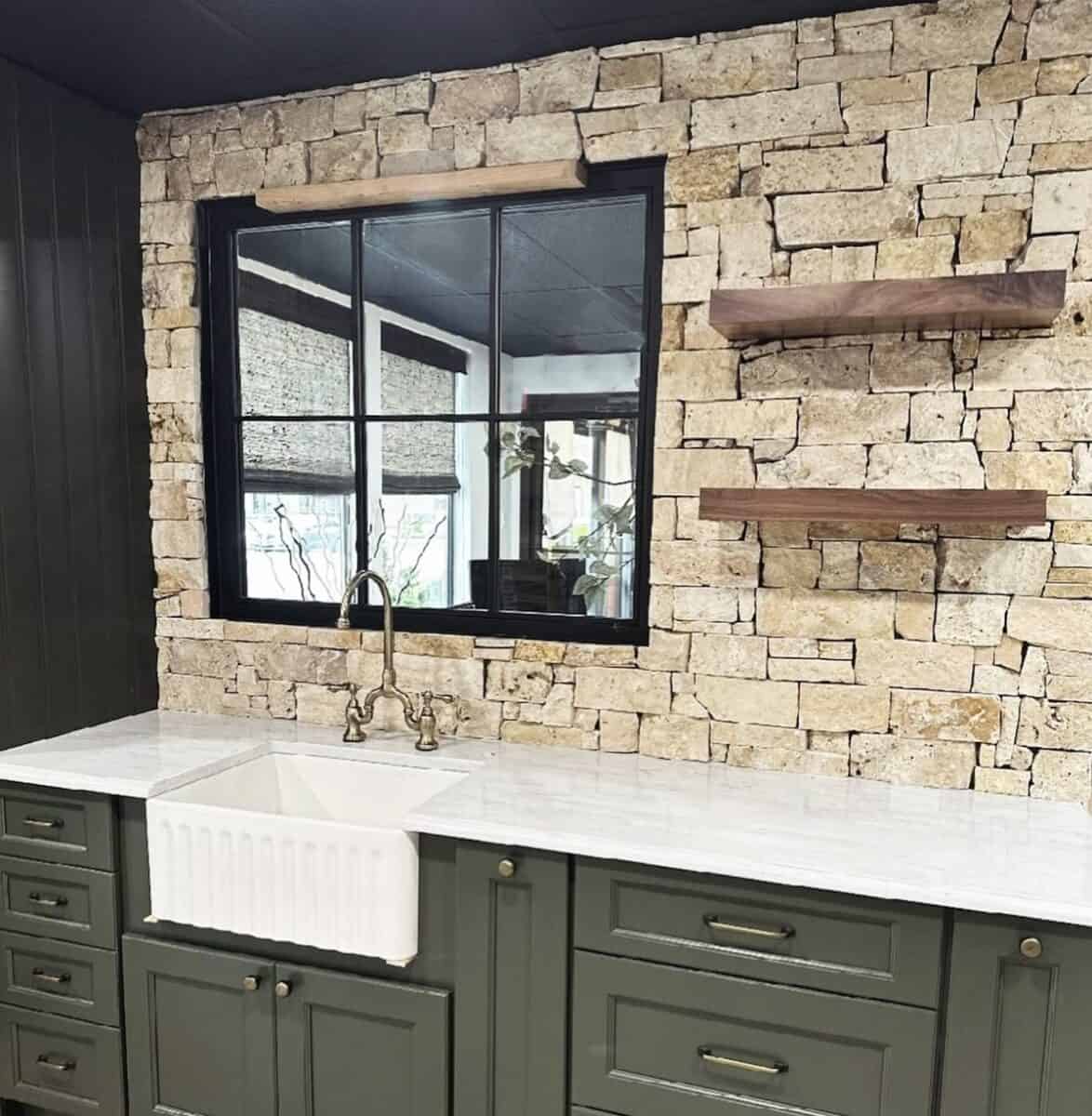 Warm toned large rustic stone on kitchen backsplash